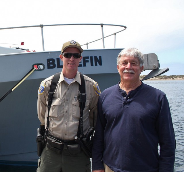 The author with Warden Ryan Hanson in front of the Fish and Wildlife Patrol Boat Bluefin. Photo by Thomas C. Wilmer